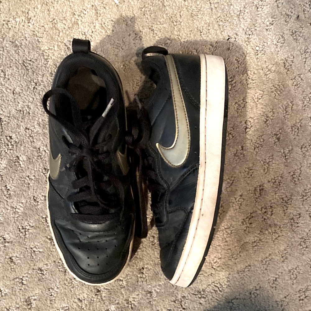 Black and gold Nike shoes size 6.5.